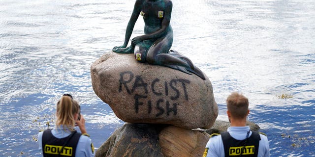 Police stand by the statue of the Little Mermaid, after it was vandalized, in Copenhagen, Denmark, Friday, July 3, 2020. 