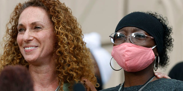 Sheneen McClain, right, and family attorney Mari Newman are seen July 3, 2020, at the memorial site across the street from where McClain's 23-year-old son, Elijah, was stopped last August by Aurora, Colo., police. (Associated Press)