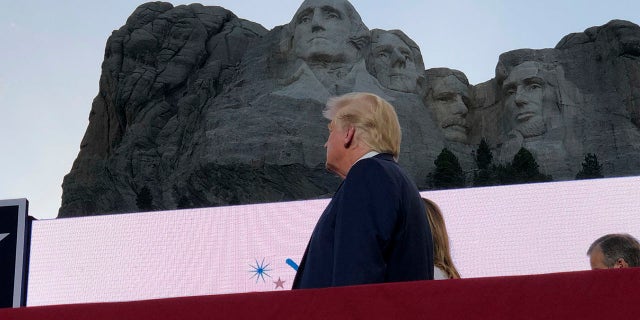 President Donald Trump watches as planes perform fly-overs of the Mount Rushmore National Monument Friday, July 3, 2020, in Keystone, S.D. (Associated Press)