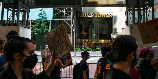 Protesters arrive to Trump Tower on Fifth Avenue during a protest, Saturday, July 4, 2020, in New York.