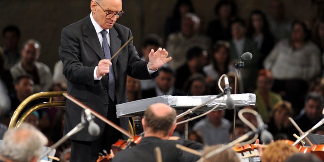 Italian composer Ennio Morricone conducts with the Budapest Symphonic Orchestra in southwestern Macedonia on July 12, 2009. Morricone, who created the coyote-howl theme for the iconic Spaghetti Western “The Good, the Bad and the Ugly” and the soundtracks such classic Hollywood gangster movies as “The Untouchables,” died Monday, July 6, 2020, in a Rome hospital at the age of 91. (AP Photo/Boris Grdanoski, file)