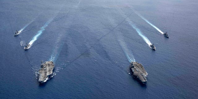 TheUSS Ronald Reagan (CVN 76) and USS Nimitz (CVN 68) Carrier Strike Groups steam in formation, in the South China Sea, Monday, July 6, 2020. (US NAVY)