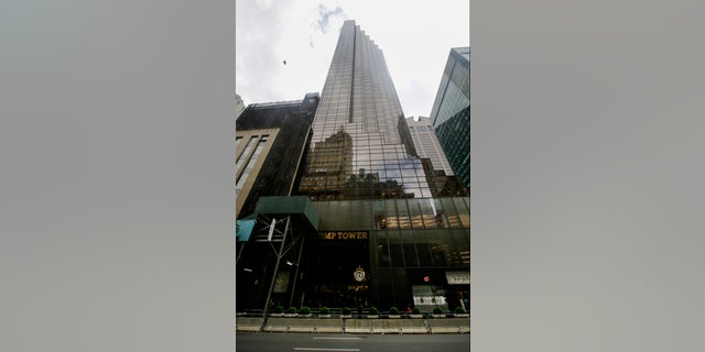 Pedestrians pass the Trump Tower building, Tuesday, July 7, 2020, in New York. (AP Photo/Frank Franklin II)