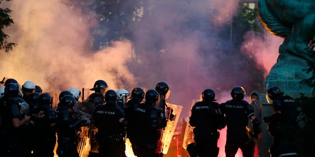 Serbian riot police clashes with protesters in Belgrade, Serbia, Wednesday, July 8, 2020. (AP Photo/Darko Vojinovic)