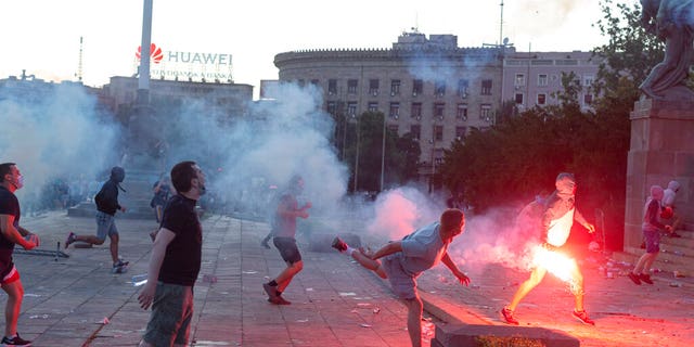 Protesters charge the building of the Serbian parliament in Belgrade, Serbia, Wednesday, July 8, 2020. (AP Photo/Marko Drobnjakovic)