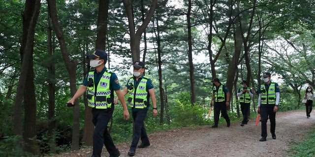 Police officers search for missing Seoul Mayor Park Won-soon in Seoul, South Korea, Thursday, July 9, 2020. (Kim Ju-sung/Yonhap via AP)