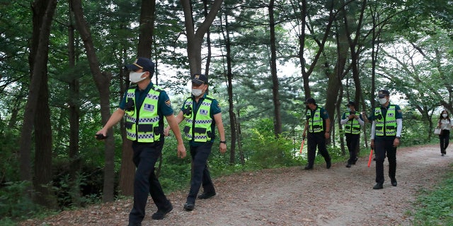 Police officers search for missing Seoul Mayor Park Won-soon in Seoul, South Korea, Thursday, July 9, 2020. (Kim Ju-sung/Yonhap via AP)