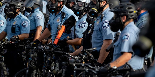 In this May 27, 2020, file photo, police gather en masse as protests continue at the Minneapolis 3rd Police Precinct in Minneapolis. The Minneapolis protests sparked others nationwide. (Carlos Gonzalez/Star Tribune via AP, File)