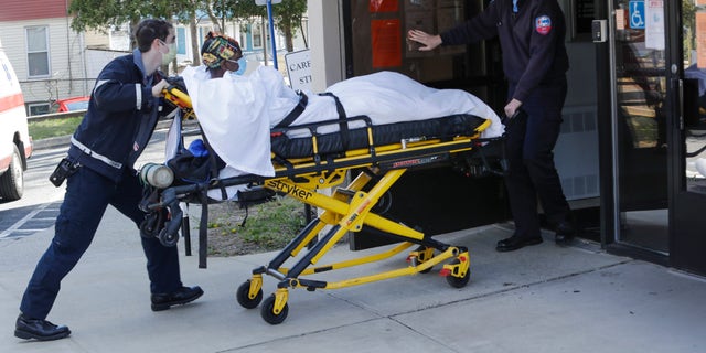 Medical workers bring a patient to the Northbridge Health Care Center in Bridgeport, Conn on April 22, 2020. (AP Photo/Frank Franklin II)