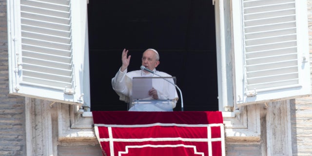 Pope Francis delivers his blessing to faithful during the Angelus prayer from the window of his studio overlooking St. Peter's Square at the Vatican, Sunday, July 12, 2020. (AP Photo/Alessandra Tarantino)