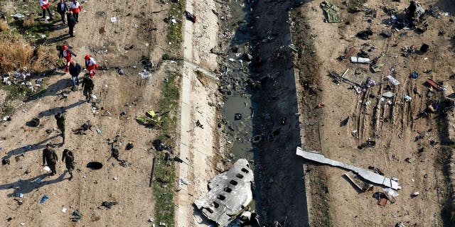 FILE: Rescue workers search the scene where a Ukrainian plane crashed in Shahedshahr, southwest of Tehran, Iran.