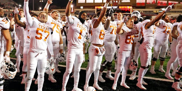 FILE: Texas players sing "The Eyes of Texas" after an NCAA college football game against Texas Tech in Lubbock, Texas.
