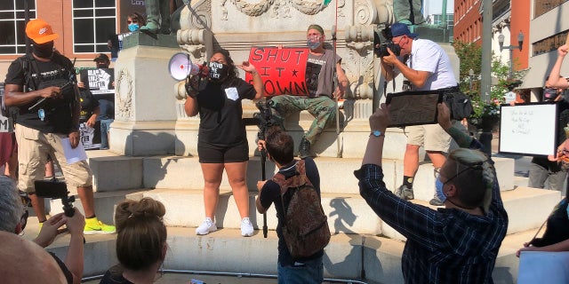 Activist Maegan Llerena addresses a crowd of protesters in Allentown, Pa. who gathered Monday, July 13, 2020, to demand accountability from police after video emerged of an officer placing his knee on a man's head and neck area outside a hospital. Police have launched an internal probe. (AP Photo/Michael Rubinkam)