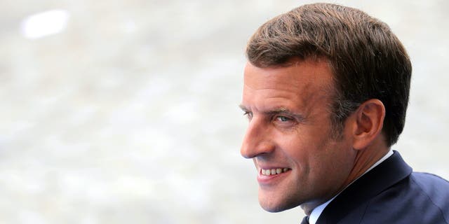 France's President Emmanuel Macron attends the Bastille Day military parade, Tuesday, July 14, 2020 in Paris. France are honoring nurses, ambulance drivers, supermarket cashiers and others on its biggest national holiday Tuesday. Bastille Day's usual grandiose military parade in Paris is being redesigned this year to celebrate heroes of the coronavirus pandemic. (Ludovic Marin, Pool via AP)