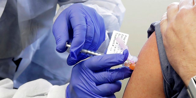 A subject receives a shot in the first-stage safety study clinical trial of a potential vaccine by Moderna for COVID-19, the disease caused by the new coronavirus on March 16, 2020. (AP Photo/Ted S. Warren, File)