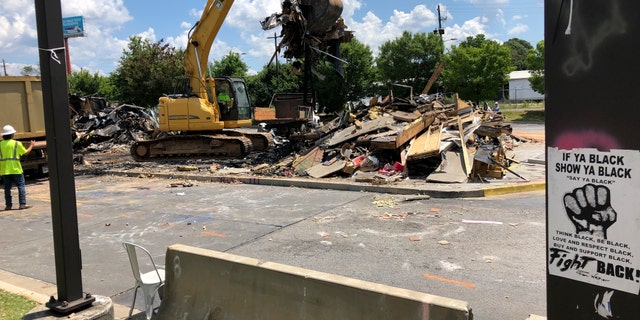 A Wendy's restaurant is demolished Tuesday, July 14, 2020, in Atlanta. The resaurant was the scene where Rayshard Brooks was shot and killed on June 12, 2020, by an Atlanta police officer following a struggle during a DUI arrest. (AP Photo/Jeff Amy)