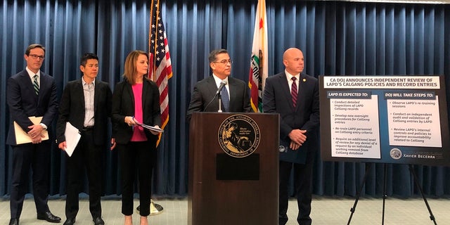 California Attorney General Xavier Becerra, second from right, revoked access to entries Los Angeles police made in the state's gang database after three officers were charged with falsifying records, authorities said Tuesday, July 14, 2020. (AP Photo/Stefanie Dazio, File)