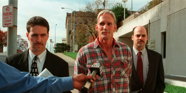 In this 1998 photo, Wesley Ira Purkey, center, is escorted by police officers in Kansas City, Kan., after he was arrested in connection with the death of 80-year-old Mary Ruth Bales. Purkey was also convicted of kidnapping and killing a 16-year-old girl and is scheduled to be executed on July 15, 2020, in Terre Haute, Ind. (Jim Barcus/The Kansas City Star via AP)