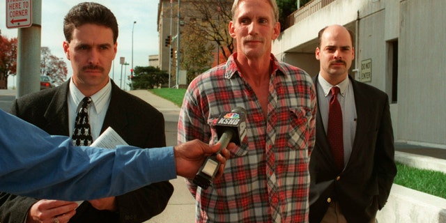 In this 1998 photo, Wesley Ira Purkey, center, is escorted by police officers in Kansas City, Kan., after he was arrested in connection with the death of 80-year-old Mary Ruth Bales. Purkey was also convicted of kidnapping and killing a 16-year-old girl and is scheduled to be executed on July 15, 2020, in Terre Haute, Ind. (Jim Barcus/The Kansas City Star via AP)