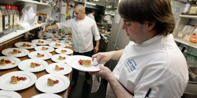 In this 2012 file photo, chef and owner Josiah Slone, right, prepares a foie gras dish at Sent Sovi restaurant in Saratoga, Calif. Foie gras is back on the menu in California after a judge ruled the rich dish can't be prevented from being brought in from out of state. (AP Photo/Marcio Jose Sanchez, File)