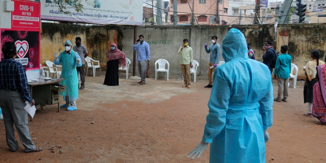 Indian people form a queue to get a nasal swab test for the coronavirus at Government Fever hospital in Hyderabad, India, Wednesday, July 15, 2020. India is the third worst-affected nation by the coronavirus pandemic. (AP Photo/Mahesh Kumar A.)