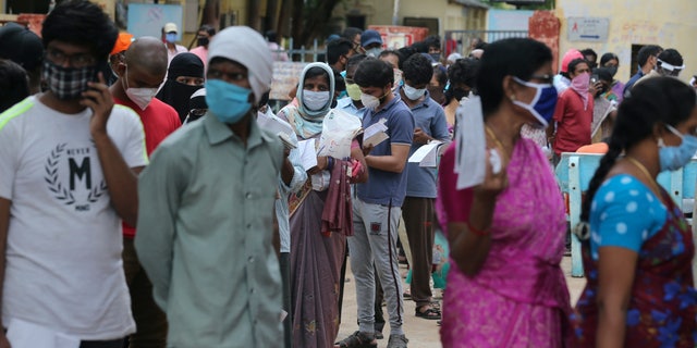 Indian people form a queue to get a nasal swab test for the coronavirus at Government Fever hospital in Hyderabad, India, Wednesday, July 15, 2020. India is the third worst-affected nation by the coronavirus pandemic. (AP Photo/Mahesh Kumar A.)