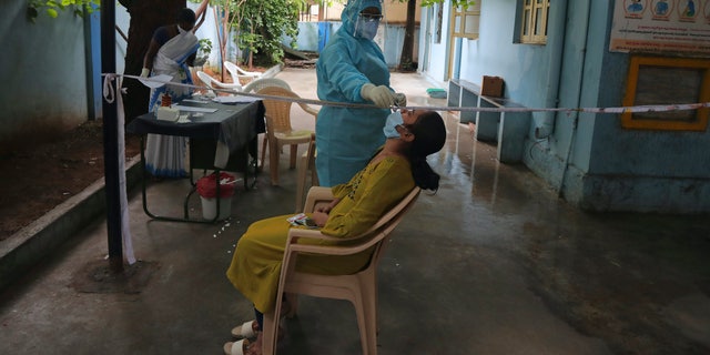 A woman gets a nasal swab taken to test for the coronavirus at Government urban primary health center in Hyderabad, India, Wednesday, July 15, 2020. India is the third worst-affected nation by the coronavirus pandemic. (AP Photo/Mahesh Kumar A.)