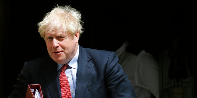 Britain's Prime Boris Johnson leaves 10 Downing Street to attend the weekly Prime Minister's Questions session, in parliament in London, Wednesday, July 15, 2020. (AP Photo/Frank Augstein)