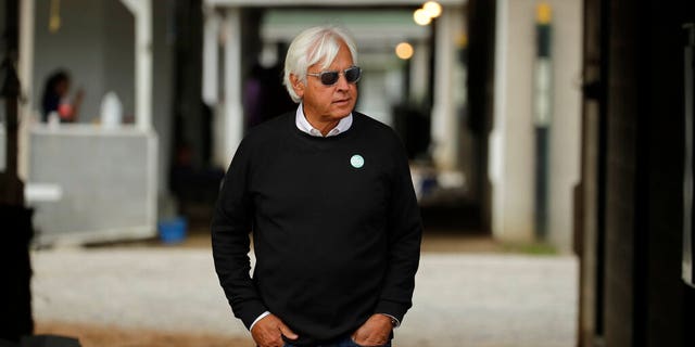 FILE - In this Wednesday, May 1, 2019, file photo, trainer Bob Baffert looks out from his barn before a workout at Churchill Downs in Louisville, Ky. Two-time Triple Crown-winning trainer Baffert has been suspended for 15 days by the Arkansas Racing Commission after two of his horses tested positive for a banned substance. The commission says in a ruling that the suspension runs from Aug. 1 to Aug. 15, 2020. (AP Photo/Charlie Riedel, File)