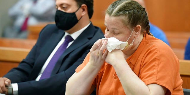JoAnn Cunningham cries and wipes her nose during her sentencing hearing Thursday, July 16, 2020, in Woodstock, Ill. Cunningham pled guilty in December to killing her five-year-old son Andrew "A.J." Freund in April 2019 in her Crystal Lake home. She was sentenced Friday to 35 years in prison. (John Starks/Daily Herald via AP, Pool)