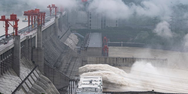 In this photo released by China's Xinhua News Agency, water flows out from sluiceways at the Three Gorges Dam on the Yangtze River near Yichang in central China's Hubei Province, Friday, July 17, 2020. Engorged with more heavy rains, China's mighty Yangtze River is cresting again, bringing fears of further destruction as seasonal floods that already have left more than a hundred people dead or missing have grown in force since last month. (Zheng Jiayu/Xinhua via AP)