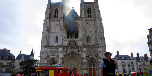 Fire fighters brigade work to extinguish the blaze at the Gothic St. Peter and St. Paul Cathedral, in Nantes, western France, Saturday, July 18, 2020. (AP Photo/Laetitia Notarianni)