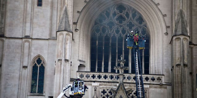 The fire shattered stained glass windows and sent black smoke spewing from between its two towers of the 15th-century cathedral, which also suffered a serious fire in 1972.