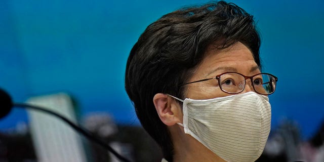 Hong Kong Chief Executive Carrie Lam listens to reporters questions during a press conference held in Hong Kong, Sunday, July 19, 2020. (AP Photo/Vincent Yu)