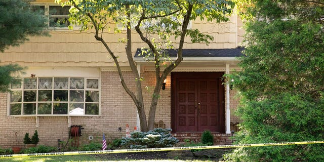 Crime scene tape surrounds the home of U.S. District Judge Esther Salas, Monday, July 20, 2020, in North Brunswick, N.J. A gunman posing as a delivery person shot and killed Salas' 20-year-old son and wounded her husband Sunday evening at their New Jersey home before fleeing, according to judiciary officials. 