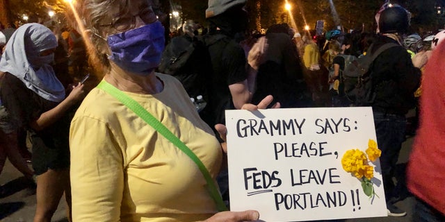 Mardy Widman, a 79-year-old grandmother of five, protests the presence of federal agents outside the Mark O. Hatfield Federal Courthouse in Portland, Ore., Monday, July 20, 2020. (AP Photo/Gillian Flaccus)