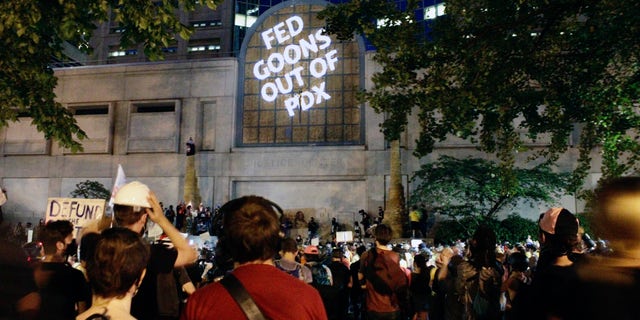 Protesters projected these words on the front of the Multnomah County Justice Center, Monday, July 20, 2020 in Portland, Ore. (AP Photo/Gillian Flaccus)
