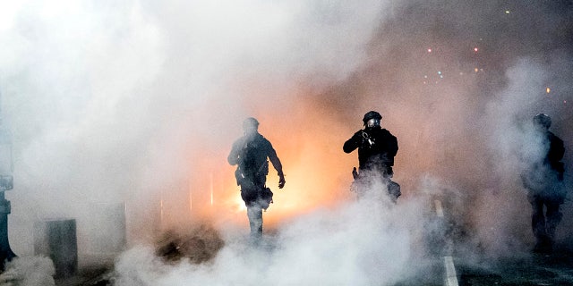 Federal officers use crowd control munitions to disperse Black Lives Matter demonstrators outside the Mark O. Hatfield United States Courthouse on Tuesday, July 21, 2020, in Portland, Ore.