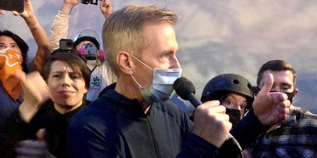Mayor Ted Wheeler speaks to people gathered in downtown Portland, Ore., Wednesday, July 22, 2020. Wheeler faced a hostile crowd of protesters, who screamed at and sharply questioned him as he tried to rally demonstrators who have clashed repeatedly with federal agents sent in by President Donald Trump to quell ongoing unrest in the city. (AP Photo/Gillian Flaccus)