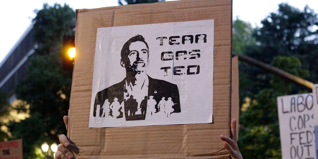 Demonstrators protest in downtown Portland, Ore., Wednesday, July 22, 2020. Gov. Ted Wheeler faced a hostile crowd of protesters, who screamed at and sharply questioned him as he tried to rally demonstrators who have clashed repeatedly with federal agents sent in by President Donald Trump to quell ongoing unrest in the city. (AP Photo/Gillian Flaccus)