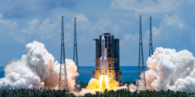 A Long March-5 rocket carrying the Tianwen-1 Mars probe lifts off from the Wenchang Space Launch Center in southern China's Hainan Province, Thursday, July 23, 2020. China launched its most ambitious Mars mission yet on Thursday in a bold attempt to join the United States in successfully landing a spacecraft on the red planet. (Cai Yang/Xinhua via AP)