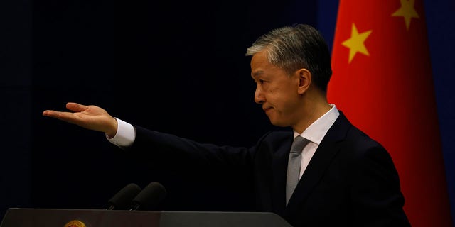 Foreign Ministry spokesperson Wang Wenbin gestures for questions during a daily briefing in Beijing Thursday, July 23, 2020. China ordered the United States on Friday, July 24, 2020 to close its consulate in the western city of Chengdu, ratcheting up a diplomatic conflict at a time when relations have sunk to their lowest level in decades. (AP Photo/Ng Han Guan)