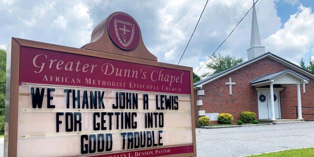 In this July 20, 2020, photo, a church sign honoring the late U.S. Rep. John Lewis sits near his family's land in Pike County, Ala. A series of services will be held to remember Lewis, beginning July 25, 2020, in his home state of Alabama. (AP Photo/Kimberly Chandler)