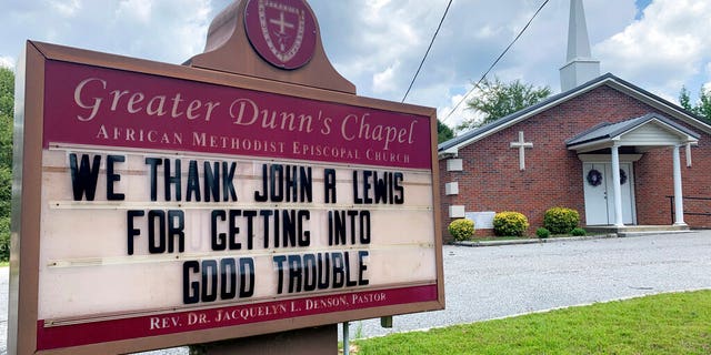 In this July 20, 2020, photo, a church sign honoring the late U.S. Rep. John Lewis sits near his family's land in Pike County, Ala. A series of services will be held to remember Lewis, beginning July 25, 2020, in his home state of Alabama. (AP Photo/Kimberly Chandler)