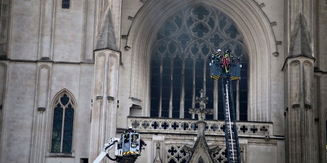 In this photo, taken on July 18, 2020, a fire brigade is working to extinguish the flames in the Gothic cathedral