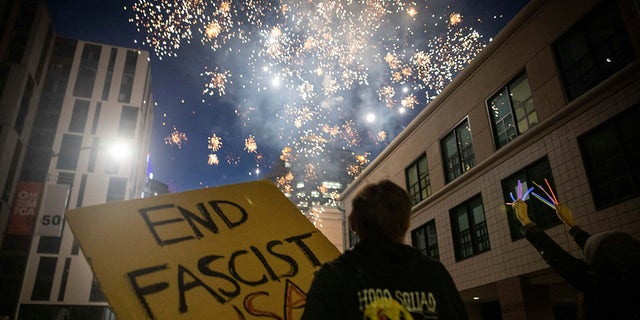 Protesters light fireworks in the middle of downtown Oakland during a protest on Saturday, July 25, 2020, in Oakland, Calif. (Associated Press)