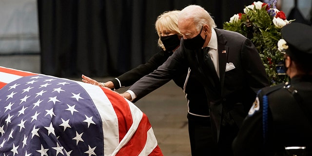 Then-Democratic presidential candidate Joe Biden and his wife Jill Biden touch the flag-covered casket of the late Representative John Lewis, D-Ga., On Capitol Hill in Washington, July 27, 2020 (Associated Press)