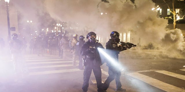 Federal officers deploy tear gas and crowd control munitions at demonstrators during a Black Lives Matter protest at the Mark O. Hatfield United States Courthouse Tuesday, July 28, 2020, in Portland, Ore. 