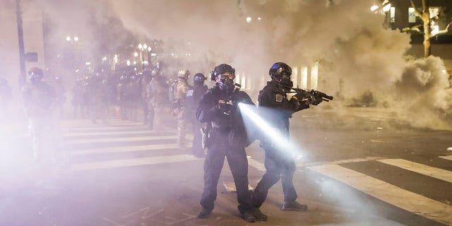 Federal officers deploy tear gas and crowd control munitions at demonstrators during a Black Lives Matter protest at the Mark O. Hatfield United States Courthouse Tuesday, July 28, 2020, in Portland, Ore. 