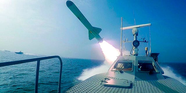 In this photo released Tuesday, July 28, 2020, by Sepahnews, a Revolutionary Guard's speed boat fires a missile during a military exercise. Iranian commandos also fast-roped down from a helicopter onto a replica of an aircraft carrier in the exercise called "Great Prophet 14." The drill appears aimed at threatening the U.S. amid tensions between Tehran and Washington. (Sepahnews via AP)